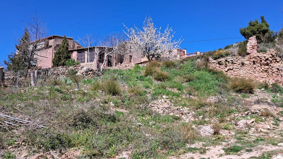 Paisaje de montaña con casa en ruinas de fondo